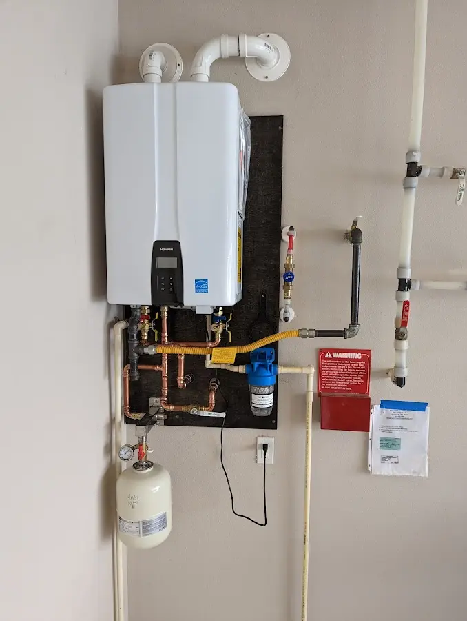 Professional plumber installing copper piping in a West Milwaukee home